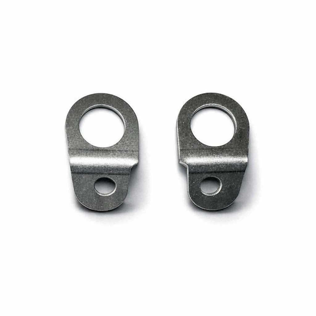 Two stainless steel angle-peak tie-down brackets shown side by side on a white background, with enhanced detail and a soft shadow underneath each bent edge.